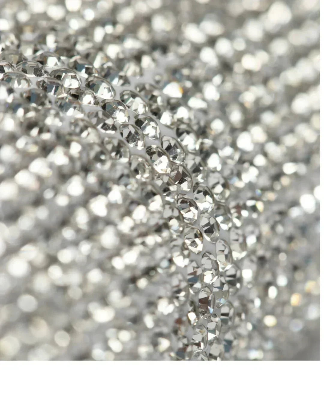 Close-up of a string of clear rhinestones on a blurred background